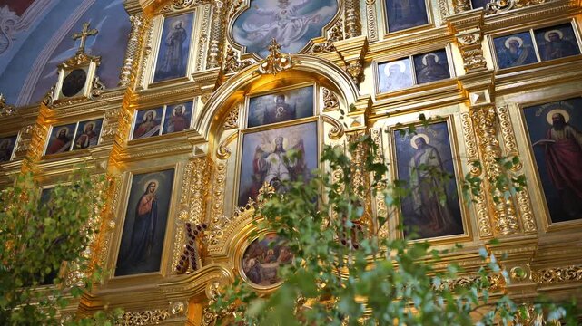 Golden iconostasis in an Orthodox church, depicting religious icons and saints