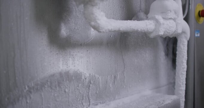 Thick frost layer on frozen evaporator in industrial freezer
