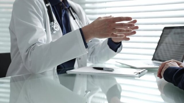Doctor discussing medical information and treatment options with patient in a clinic, providing professional healthcare consultation and modern diagnostic services