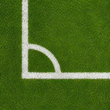 Close-up of a white corner line with a curved marking on a green artificial turf sports field.