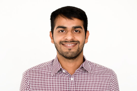 Smiling man in checkered shirt.