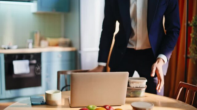 Businessman packing briefcase in morning kitchen. Closeup of work bag lunch