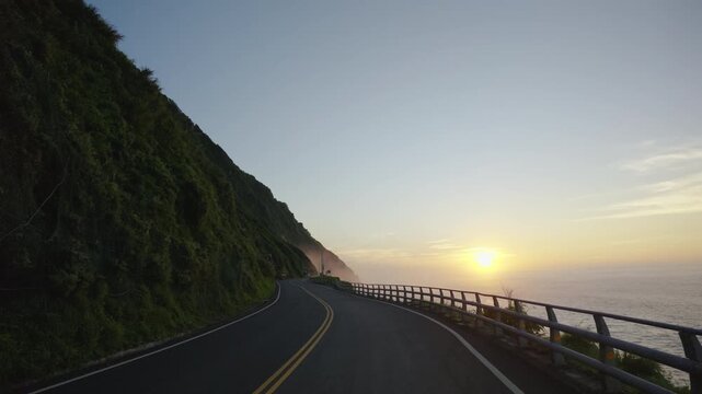 Driving on beautiful coast roads in colorful sunrise