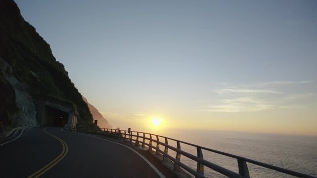 Driving on beautiful coast roads in colorful sunrise