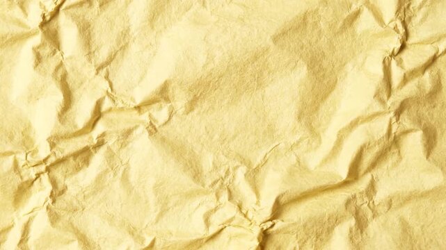 Crumpled yellow paper texture with detailed creases and shadows