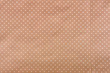 Tan polka dot fabric, close up angle © angintaravichian