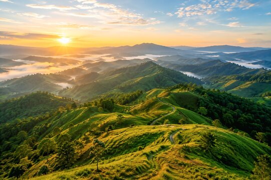 Breathtaking Aerial View of Green Rolling Hills and Mountain Ridges at Sunrise, Scenic Valley Landscape with Winding Path and Morning Mist
