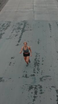 Elevated shot of female runner closing in toward the camera