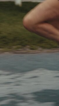 Close up of female runner's legs striking wet pavement