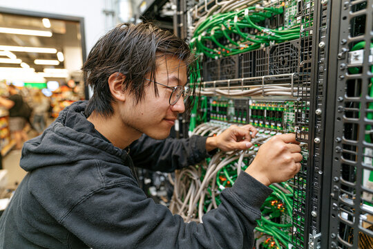 Technician installing an edge server in a retail backroom