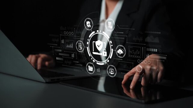 Business Professional Using Laptop with Cybersecurity Icons and Data Protection Symbols in Dark Office Environment. Entropy.