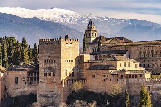 View from the Mirador de San Nicolas of Alhambra and the snow-capped mountains of the Sierra Nevada, Granada, Andalusia, Spain