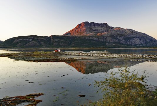 Fjord landscape with lake during sunset, reflected in calm water, Offers&ouml;y, Kystriksveien, Nordland, Norway