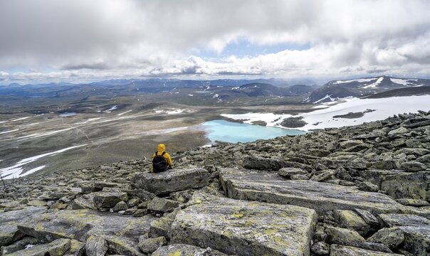 Mountaineer in the tundra, Fjell, barren landscape with mountain lake, hike to Mount Sn&oslash;hetta, Dovrefjell National Park, Oppdal, Norway