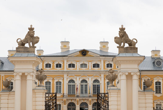 Grand Baroque Palace Gate With Lion Statues, Ornate Columns, Clock Pediment and Ironwork Entrance