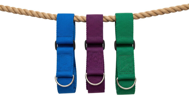 Three colorful yoga straps hanging on a rope. Fitness exercise belts for stretching practice.