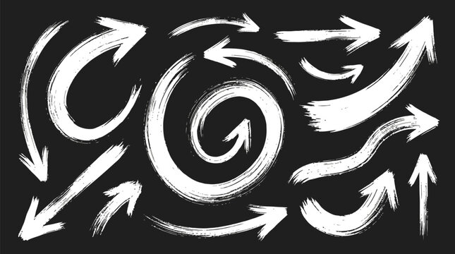 Hand drawn white brush stroke arrows arranged on a dark black textured paper background surface