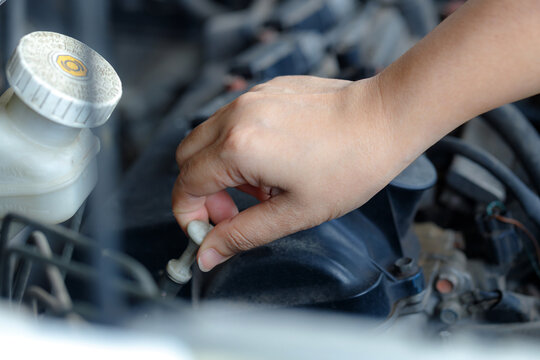 Mechanic Hand Checking Engine Oil Level