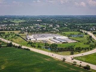 Aerial view of a modern data center facility with solar panels on the roof, cooling units and server buildings © marchello74