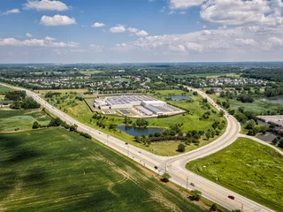 Aerial view of a modern data center facility with solar panels on the roof, cooling units and server buildings © marchello74