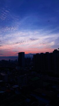 Airplane Flying Over Guangzhou City at Dusk Colorful Sky Slow Movement