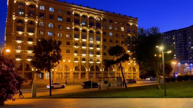 City Traffic in Front of a Brightly Lit Building After Sunset in Baku City