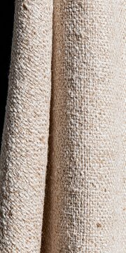 Coarse linen fabric texture with uneven slubbed threads and a soft vertical fold, tactile neutral textile background for interior and product design