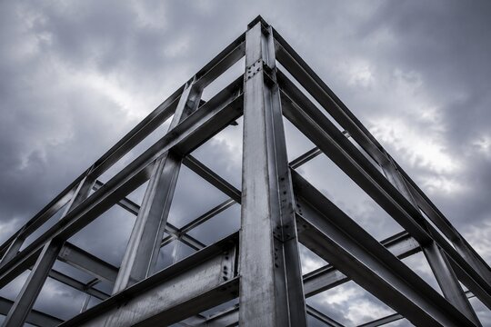 exposed. Industrial metal framework against cloudy sky, showcasing structural textures with dramatic lighting. travel magazines.
