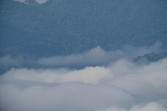 Breathtaking aerial view of misty valleys and lush green tropical rainforest mountains at dawn