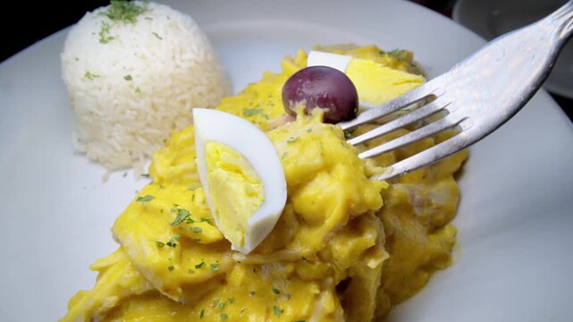 Aji de Gallina served on a bed of rice. Typical Peruvian food