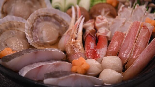 Fresh seafood hot pot ingredients beautifully arranged with kaiseki premium fish and vegetables