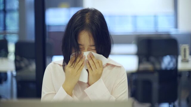 Young Asian woman working at office and have a pain office syndrome