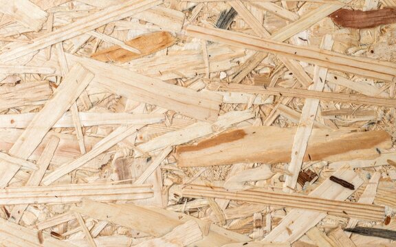 OSB board texture background, oriented strand board wood panel close up, compressed wooden chipboard surface for construction and carpentry