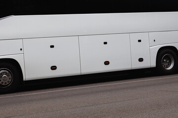 a part of the body of a white bus on the road © Farkhad