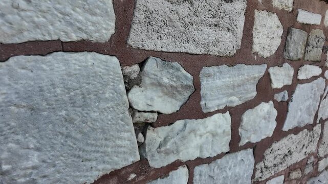 Close-up view of a stone wall with different textures