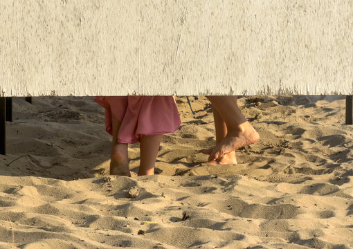 Two barefoot people in a changing room on the beach
