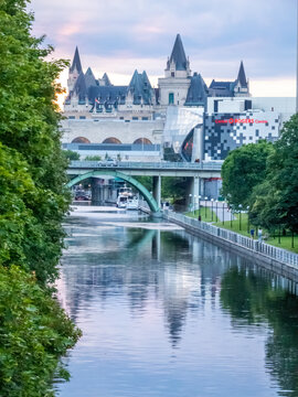 Ottawa, Ontario, Canada. July 18, 2026. Scenic view of the Rideau Canal reflecting the historic Fairmont Ch&acirc;teau Laurier hotel at dusk.