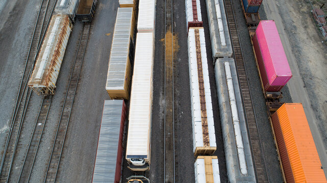 Overhead view shows railway tracks with freight containers