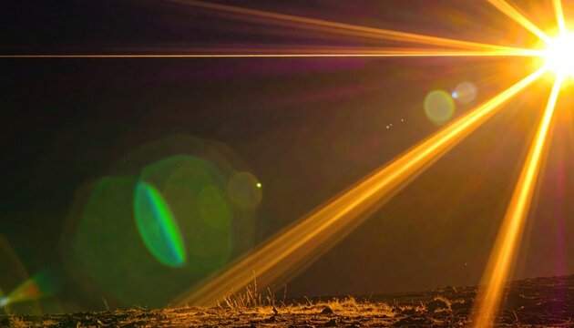 Bright Sun Flare with Lens Effect Over Landscape at Dusk