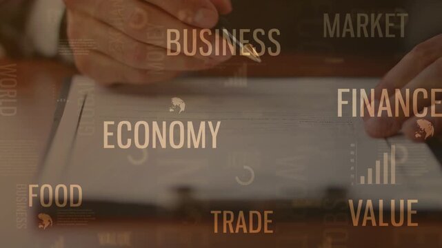 Close-up of a businessman hand signing a document with a pen, overlaid with floating golden text like FINANCE, BUSINESS, MARKET, and TRADE. Represents corporate deals.
