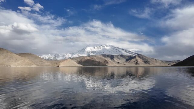 Scenic view of Muztagh Ata snow mountain reflection in dark waters of Karakul Lake Xinjiang China