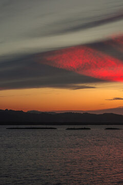Sunset Over Water with Mountain Silhouette