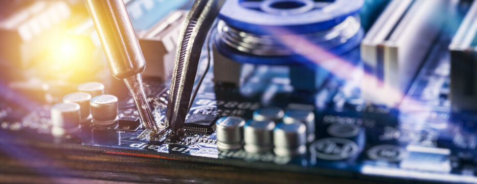 Electronic engineering and PC maintenance background. Micro-welding process on blue PCB with glowing light effects.