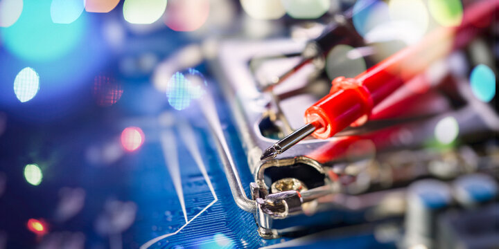 Futuristic computer repair and diagnostics concept. Multimeter testing a processor socket with cinematic light flares.