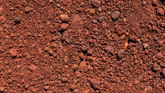 Rough red laterite soil and gravel texture background