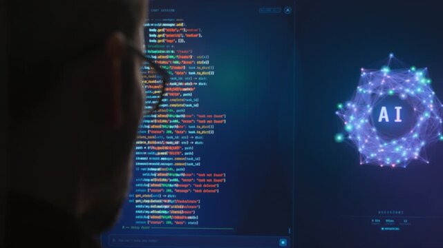 Close-up from behind of software engineer working with AI assistant, programming on a large monitor, Artificial intelligence agent writing code, helping with software development. Copy space