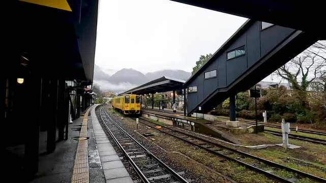 Yufuin Express Yellow Train at Yufuin  Station in Oita Japan - This train go to Hataka Statin - Travel by train on North Kyushu - Transport Footage   