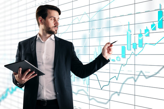 Confident trader with tablet pointing pen at rising candlestick and line graph in photographic style on white background, concept of stock analysis and growth