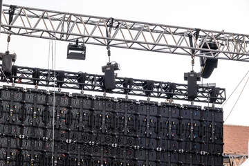 a temporary scaffolding structure built to support a large outdoor LED video wall, often used for concerts or events © Roberto Sorin