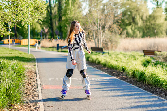 Teen Girl Roller Skating In The Park